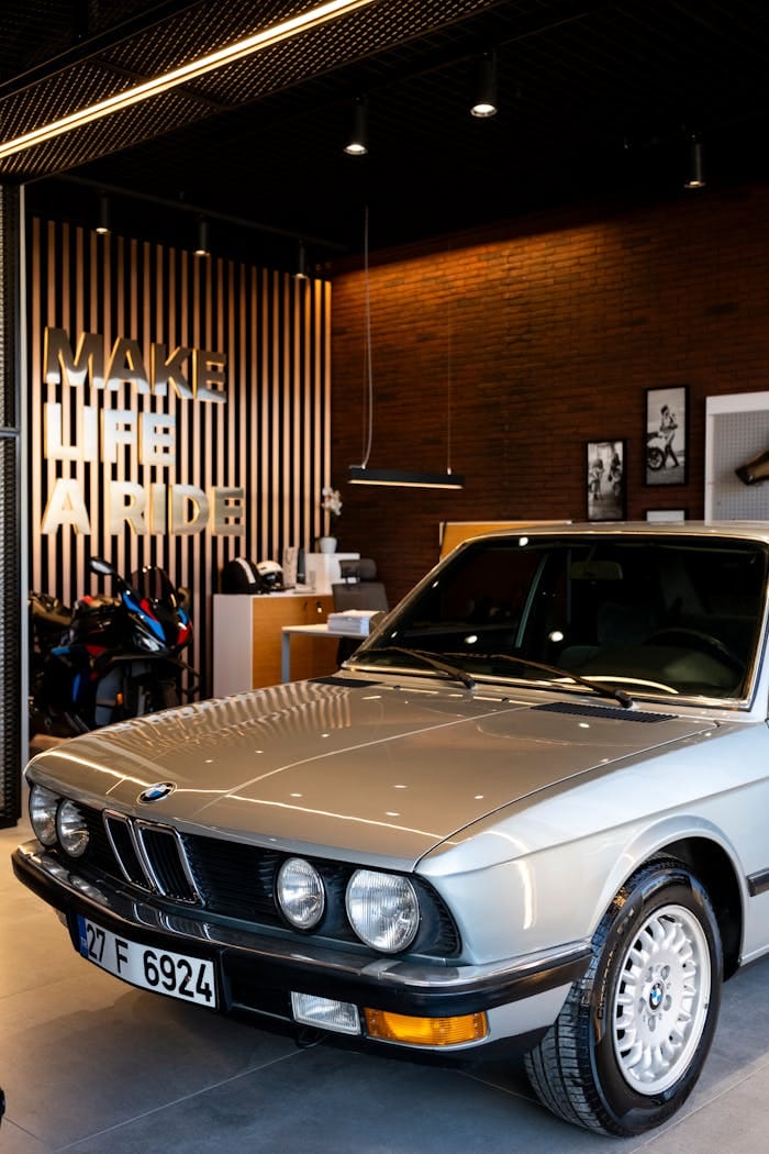 services-01 Classic car displayed in a stylish, modern showroom with retro design accents.